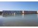 Beautiful waterfront condo view showcasing building exterior, boat docks and blue skies at 5935 30Th S Ave # 204, Gulfport, FL 33707
