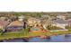 Aerial view of a property featuring a pool, patio, and backyard near a pond in a quiet neighborhood at 6239 French Creek Ct, Ellenton, FL 34222