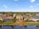 Aerial view showcases a home with a private pool, patio, and manicured lawn in a desirable neighborhood at 6239 French Creek Ct, Ellenton, FL 34222