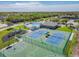 Aerial view of the community pool, tennis, and basketball courts, plus playground at 6239 French Creek Ct, Ellenton, FL 34222