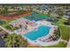 Aerial view of the community swimming pool and clubhouse surrounded by lush landscaping at 6239 French Creek Ct, Ellenton, FL 34222