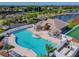 Aerial view of the community swimming pool with an expansive deck and lounge chairs at 6239 French Creek Ct, Ellenton, FL 34222
