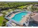 Aerial view of the community pool with a spacious deck and lounge seating at 6239 French Creek Ct, Ellenton, FL 34222