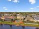 Aerial view showcases a home with a private pool, patio, and manicured lawn in a desirable neighborhood at 6239 French Creek Ct, Ellenton, FL 34222
