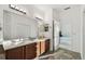 Spacious bathroom featuring a double sink vanity, tile flooring, and entry to bedroom at 6239 French Creek Ct, Ellenton, FL 34222