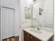 Well-lit bathroom features a large mirror and single sink, with a closet and the toilet visible at 6239 French Creek Ct, Ellenton, FL 34222