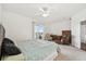 Spacious bedroom with carpet, ceiling fan, and sliding doors leading to an outdoor patio with scenic views at 6239 French Creek Ct, Ellenton, FL 34222