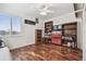Bedroom with hardwood floors, a ceiling fan, and a bright window overlooking the neighborhood at 6239 French Creek Ct, Ellenton, FL 34222