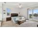 Bedroom featuring a decorative headboard, bench, ceiling fan and sliding glass doors to the outdoor patio at 6239 French Creek Ct, Ellenton, FL 34222
