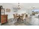 Bright dining area with a chandelier, table with seating for four, and sliding glass doors to the backyard at 6239 French Creek Ct, Ellenton, FL 34222