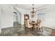 Charming dining area with elegant chandelier, table with seating for four, and unique tile flooring at 6239 French Creek Ct, Ellenton, FL 34222