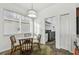 Cozy dining area featuring a glass table, decorative rug, and access to the laundry room at 6239 French Creek Ct, Ellenton, FL 34222