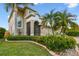 Inviting home features a screened entry, well-manicured lawn, and lovely landscaping details at 6239 French Creek Ct, Ellenton, FL 34222