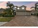 Charming home featuring a well-manicured lawn, decorative driveway, and a spacious three-car garage at 6239 French Creek Ct, Ellenton, FL 34222