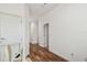 Hallway featuring hardwood floors, chair lift and white trim at 6239 French Creek Ct, Ellenton, FL 34222