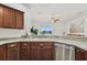 Modern kitchen featuring white sink, light countertops and pass through to living area and water view at 6239 French Creek Ct, Ellenton, FL 34222