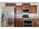 Modern kitchen features stainless steel refrigerator, range, oven and dark wood cabinets at 6239 French Creek Ct, Ellenton, FL 34222