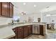 Bright kitchen with wooden cabinets, stone countertops, stainless steel appliances and an open layout at 6239 French Creek Ct, Ellenton, FL 34222