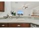 Bright kitchen featuring white sink, light countertops and pass through to living area and water view at 6239 French Creek Ct, Ellenton, FL 34222