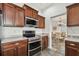 Modern kitchen features stainless steel appliances, granite countertops, and tile flooring at 6239 French Creek Ct, Ellenton, FL 34222