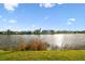 Expansive lake view from backyard with lush green lawn at 6239 French Creek Ct, Ellenton, FL 34222