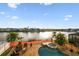 Picturesque lake view from the pool area, surrounded by tropical landscaping and luxurious homes at 6239 French Creek Ct, Ellenton, FL 34222