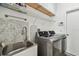 Well-equipped laundry room featuring modern washer and dryer units and ample storage at 6239 French Creek Ct, Ellenton, FL 34222