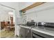 Functional laundry room with modern appliances, sink, and convenient access to the adjacent rooms at 6239 French Creek Ct, Ellenton, FL 34222