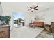 Spacious living room with sliding glass doors offering views of the pool and landscaped backyard at 6239 French Creek Ct, Ellenton, FL 34222