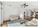 Bright living room with comfortable seating, ceiling fan, and an open layout into dining area at 6239 French Creek Ct, Ellenton, FL 34222