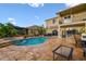 Backyard features a pool, hot tub, outdoor kitchen, and patio seating at 6239 French Creek Ct, Ellenton, FL 34222