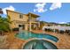Backyard oasis with sparkling pool, hot tub, outdoor kitchen, and covered patio; perfect for entertaining at 6239 French Creek Ct, Ellenton, FL 34222