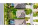 Aerial view of a home with a large backyard, surrounded by lush landscaping and a fenced perimeter at 6423 Seasound Dr, Apollo Beach, FL 33572