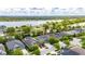 Aerial view of a residential property showcasing mature landscaping, and proximity to a lake at 6423 Seasound Dr, Apollo Beach, FL 33572