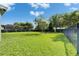Grassy backyard featuring lush landscaping and plenty of room to roam and play at 6423 Seasound Dr, Apollo Beach, FL 33572