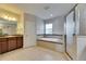 Bright bathroom showcases a vanity, soaking tub with tile surround, and a glass-enclosed shower offering spa-like experience at 6423 Seasound Dr, Apollo Beach, FL 33572