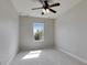 Cozy bedroom showcases a ceiling fan, neutral walls, and a window that floods the room with natural light at 6423 Seasound Dr, Apollo Beach, FL 33572