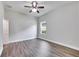 Bright bedroom featuring hardwood flooring, ceiling fan, and natural light from a window at 6423 Seasound Dr, Apollo Beach, FL 33572