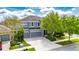 Two-story home with a three-car garage, lush landscaping, and a spacious driveway at 6423 Seasound Dr, Apollo Beach, FL 33572