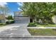 Charming two-story home with a three-car garage, manicured lawn, and mature trees at 6423 Seasound Dr, Apollo Beach, FL 33572