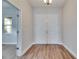 Inviting foyer with wood-look floors and double doors, showcasing a bright and welcoming entrance at 6423 Seasound Dr, Apollo Beach, FL 33572