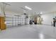 Spacious garage with ample room for parking and storage, featuring an automatic door and well-lit interior for convenience at 6423 Seasound Dr, Apollo Beach, FL 33572