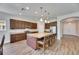 Gorgeous kitchen with an island, pendant lighting, stainless steel appliances, and wooden cabinets at 6423 Seasound Dr, Apollo Beach, FL 33572