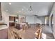 Open-concept living area with a kitchen, dining area, and hardwood floors, creating a cohesive living space at 6423 Seasound Dr, Apollo Beach, FL 33572