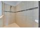 Modern shower stall with tiled walls and glass accents, offering a clean and stylish design for a refreshing experience at 6423 Seasound Dr, Apollo Beach, FL 33572