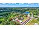 An aerial shot of the property showing the house, garden, pond, and the property's unique natural setting at 6501 62Nd N St, Pinellas Park, FL 33781