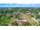 An aerial view showcases a property with multiple buildings, a well-maintained garden, and a pond at 6501 62Nd N St, Pinellas Park, FL 33781