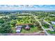 Aerial view showcases a property with multiple buildings, a well-maintained garden, and a peaceful pond at 6501 62Nd N St, Pinellas Park, FL 33781