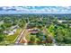 An aerial view of a rural property with a house, garden, and surrounding greenery, showing its spacious layout at 6501 62Nd N St, Pinellas Park, FL 33781