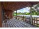 Spacious back porch with wood flooring and a serene view of the surrounding greenery and blue skies at 6501 62Nd N St, Pinellas Park, FL 33781
